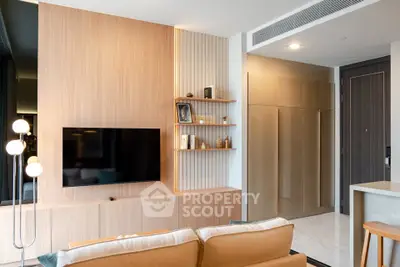 Modern living room with sleek wooden paneling and wall-mounted TV in stylish apartment.
