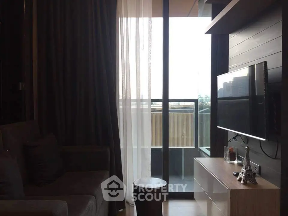 Modern living room with balcony access and stylish decor in urban apartment.