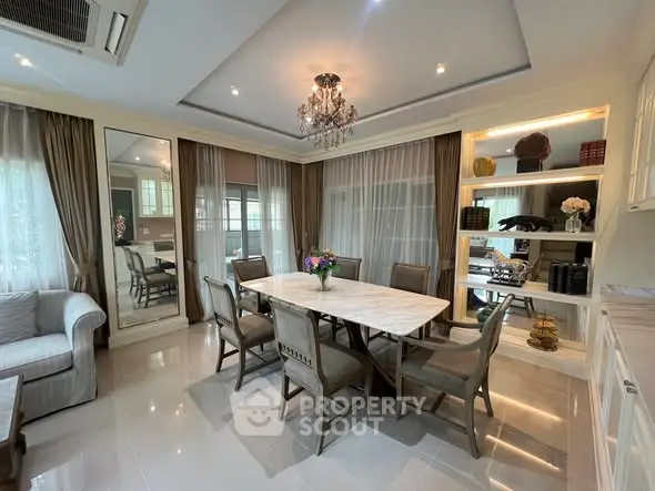 Elegant dining room with chandelier and large windows in luxury home