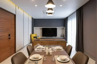 Modern living room with dining area, stylish furniture, and ambient lighting.