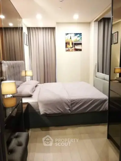 Cozy modern bedroom with elegant decor and soft lighting, perfect for relaxation.