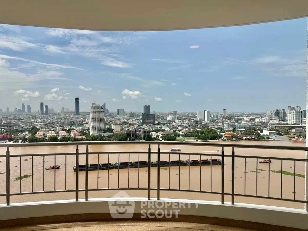 Stunning cityscape view from a high-rise balcony overlooking a river, perfect for urban living enthusiasts.
