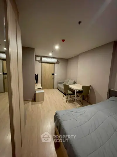 Cozy studio apartment with modern furnishings and wooden flooring