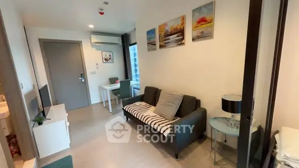 Modern living room with stylish decor and natural light in a cozy apartment.