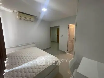 Modern bedroom with air conditioning and minimalist furniture in a bright apartment.