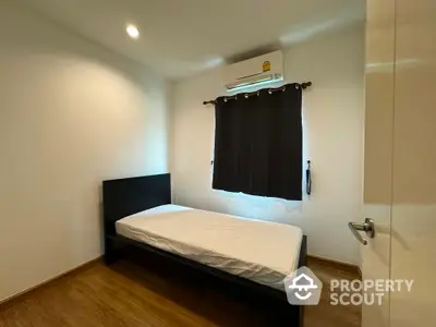 Cozy minimalist bedroom with single bed and air conditioning