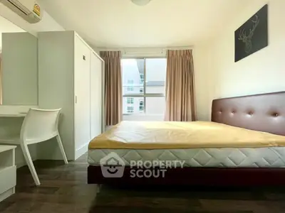 Bright and cozy bedroom with large window and modern furnishings