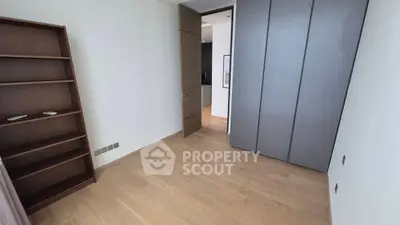 Spacious bedroom with wooden flooring and built-in wardrobe