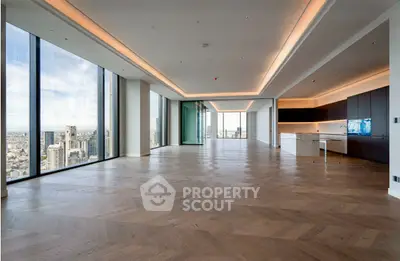Spacious modern living room with panoramic city views and elegant wooden flooring.