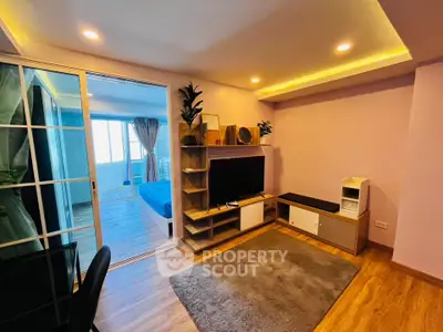 Modern living room with stylish decor and open view to bedroom