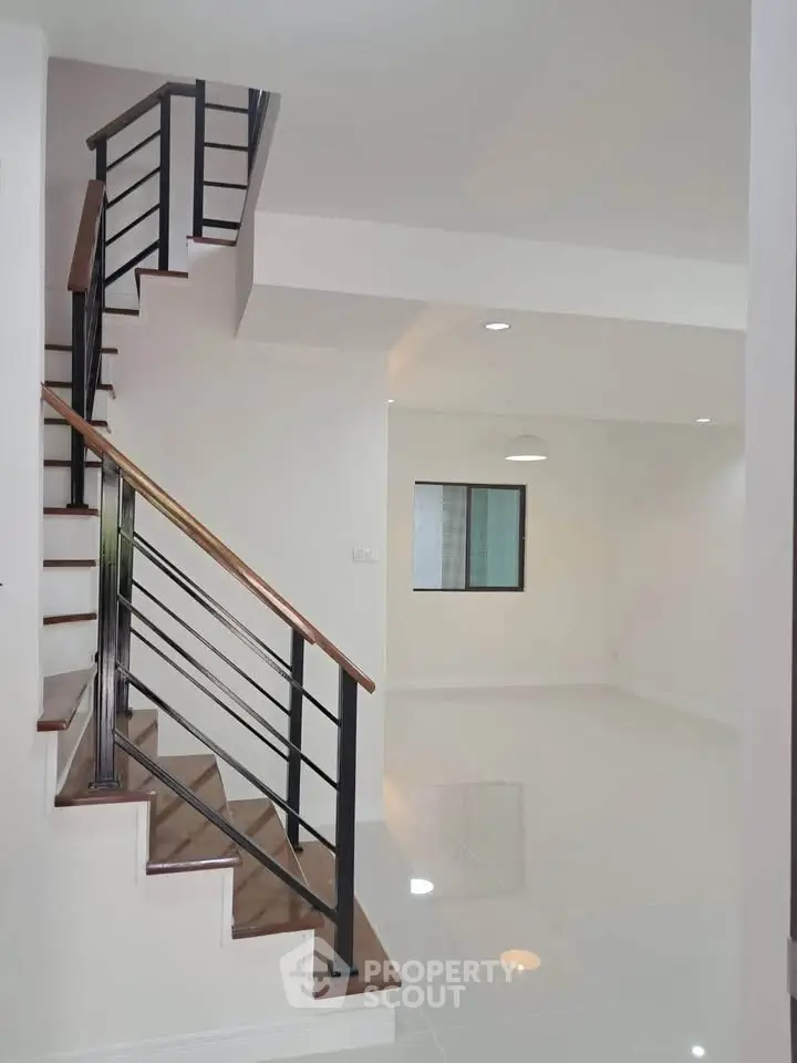 Modern interior with sleek staircase and open living space, perfect for contemporary living.