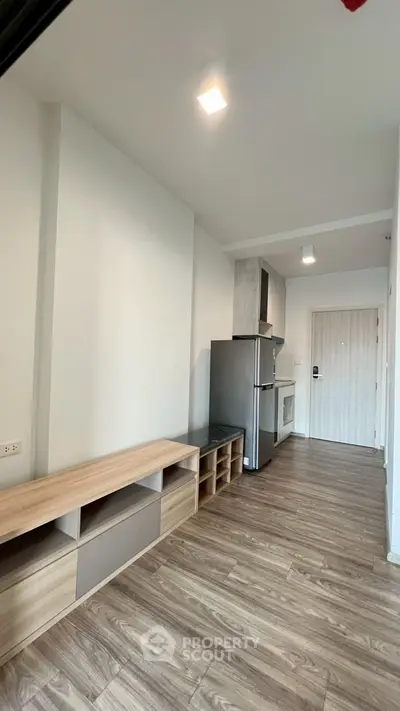 Modern apartment interior with sleek kitchen and wooden flooring