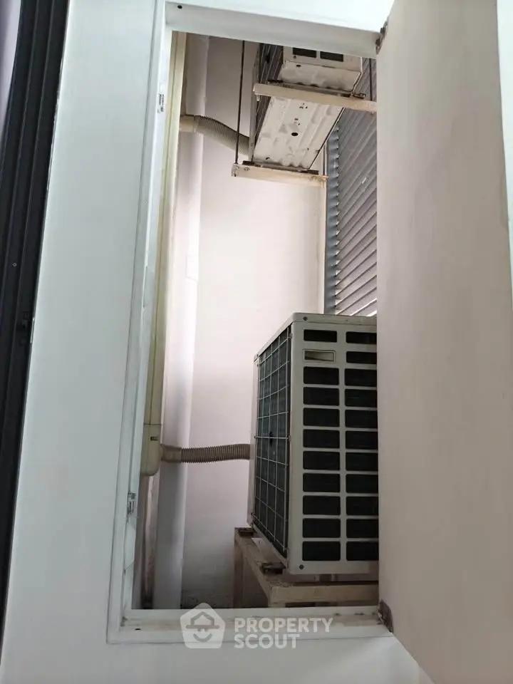 Air conditioning units in a building's exterior utility area, showcasing essential HVAC systems.