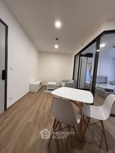 Modern living room with sleek furniture and wooden flooring, perfect for contemporary living.