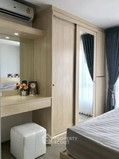Modern bedroom with built-in wardrobe and vanity, featuring elegant curtains and a cozy atmosphere.