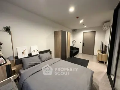 Modern bedroom with stylish decor and cozy ambiance in a contemporary apartment.