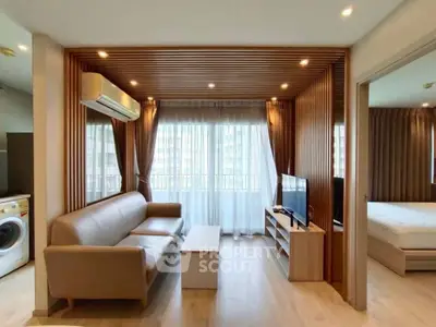 Modern living room with wooden accents and natural light, featuring a cozy sofa and flat-screen TV.