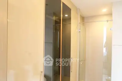 Modern bathroom with glass shower and sleek cabinetry