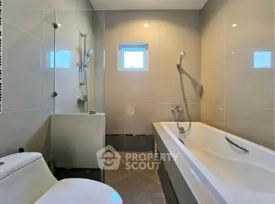 Modern bathroom with sleek design and bathtub in contemporary home.