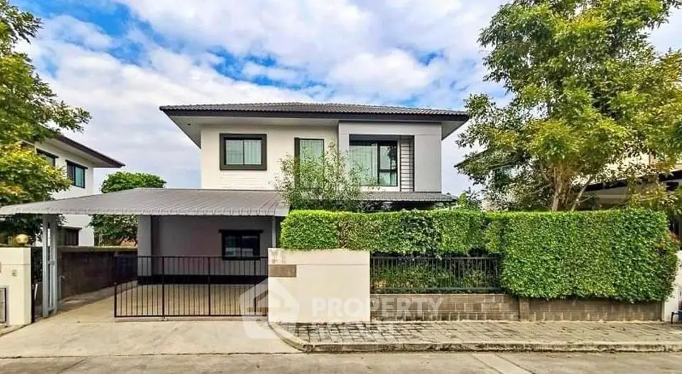 Modern two-story house with lush greenery and spacious driveway