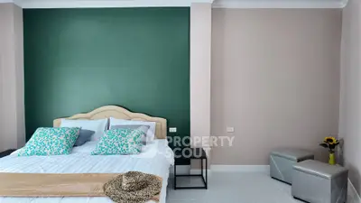 Modern bedroom with stylish decor and accent wall, perfect for relaxation.