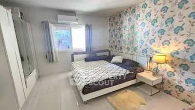 Charming bedroom with floral accent wall and cozy decor