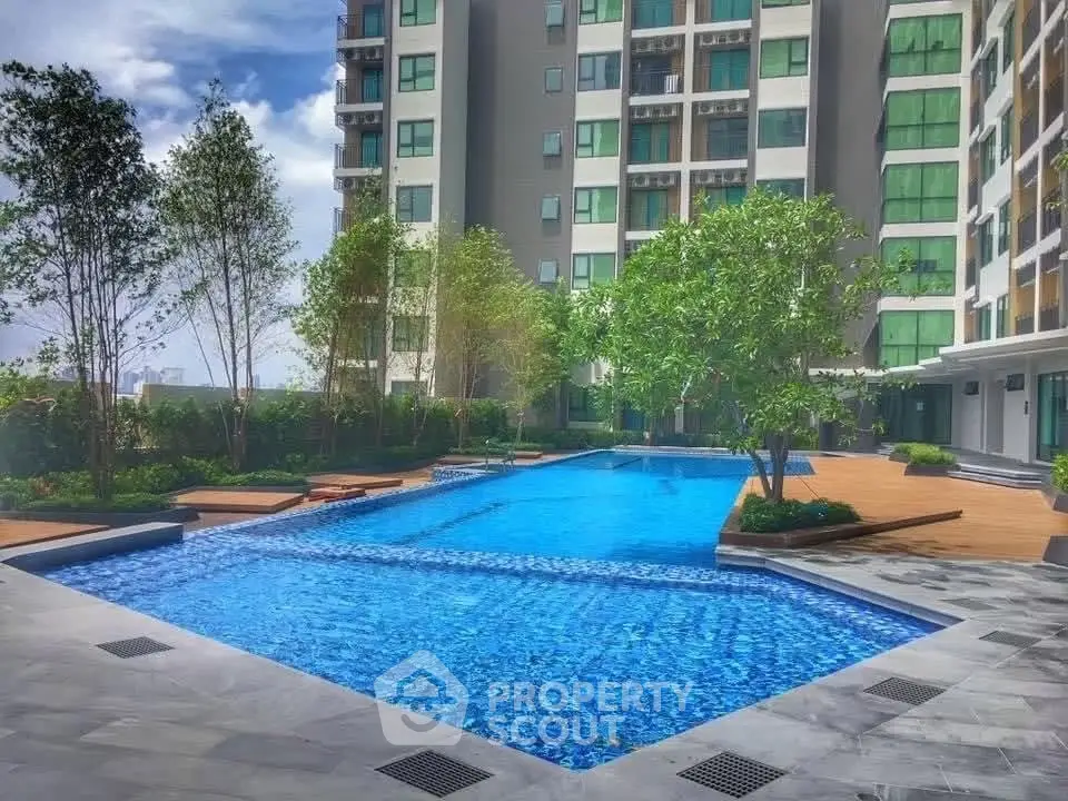 Luxurious condominium with stunning pool and lush greenery, perfect for relaxation and leisure.