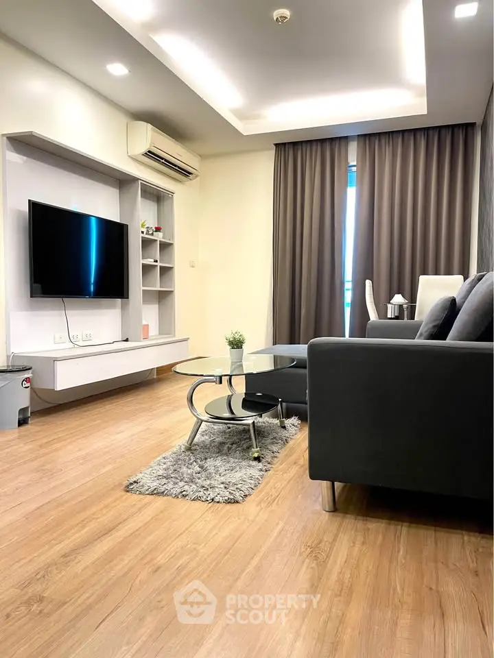 Modern living room with sleek furniture and wooden flooring