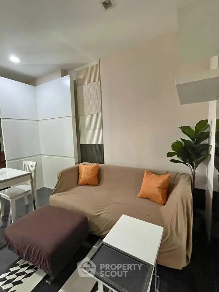 Cozy living room with modern decor and comfortable seating in a stylish apartment.
