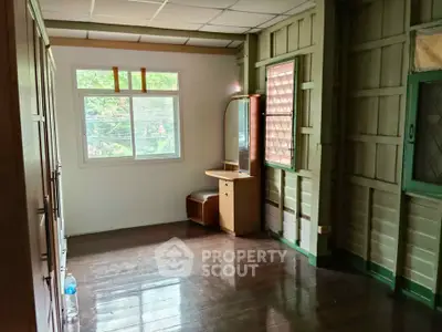 Charming rustic room with wooden floors and vintage vanity, perfect for cozy living.