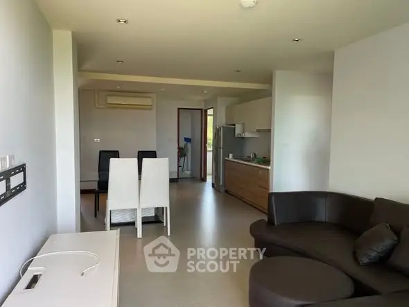 Spacious modern living room with open kitchen and stylish furniture