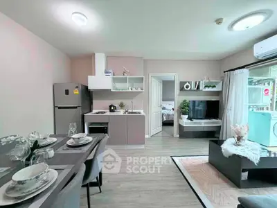 Modern open-plan living room and kitchen with stylish decor and natural light