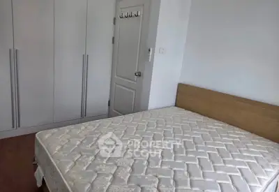 Spacious bedroom with large wardrobe and comfortable bed in modern apartment.