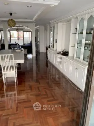 Spacious living room with elegant wooden flooring and built-in cabinets, perfect for family gatherings.