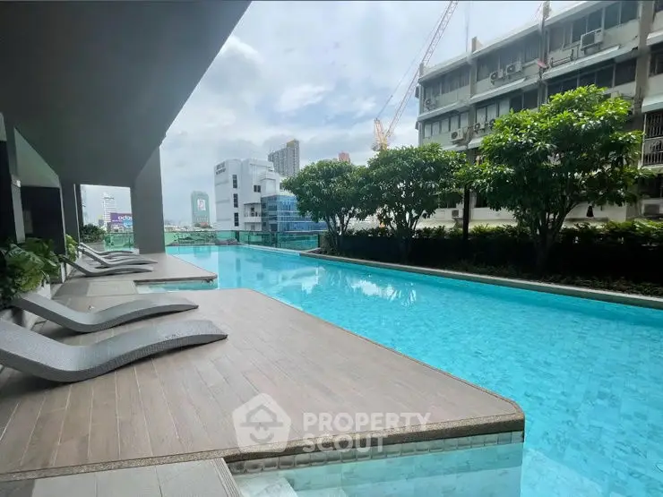 Luxurious rooftop pool with city views and modern lounge chairs