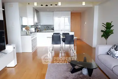 Modern open-layout living room with sleek kitchen and stylish furniture