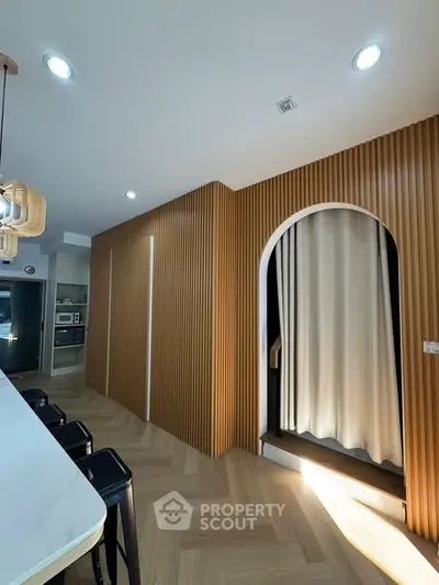 Modern kitchen with sleek design and wooden accents, featuring a stylish open layout.