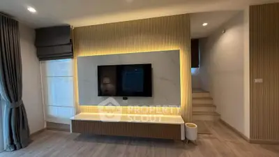 Modern living room with stylish TV wall and ambient lighting