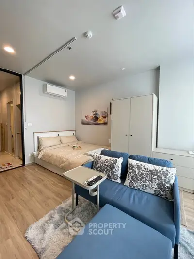 Modern studio apartment with cozy living area and stylish decor