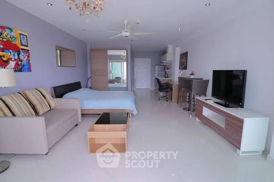 Modern studio apartment with open layout, featuring a cozy living area and stylish kitchen.