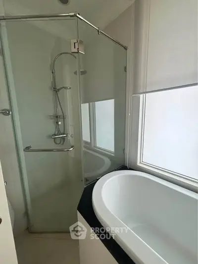 Modern bathroom with glass shower and sleek bathtub design