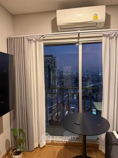 Modern living room with city view, featuring air conditioning and stylish decor, perfect for urban living.