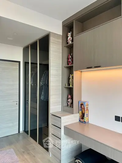 Modern study room with built-in desk and storage, featuring sleek cabinetry and stylish decor.