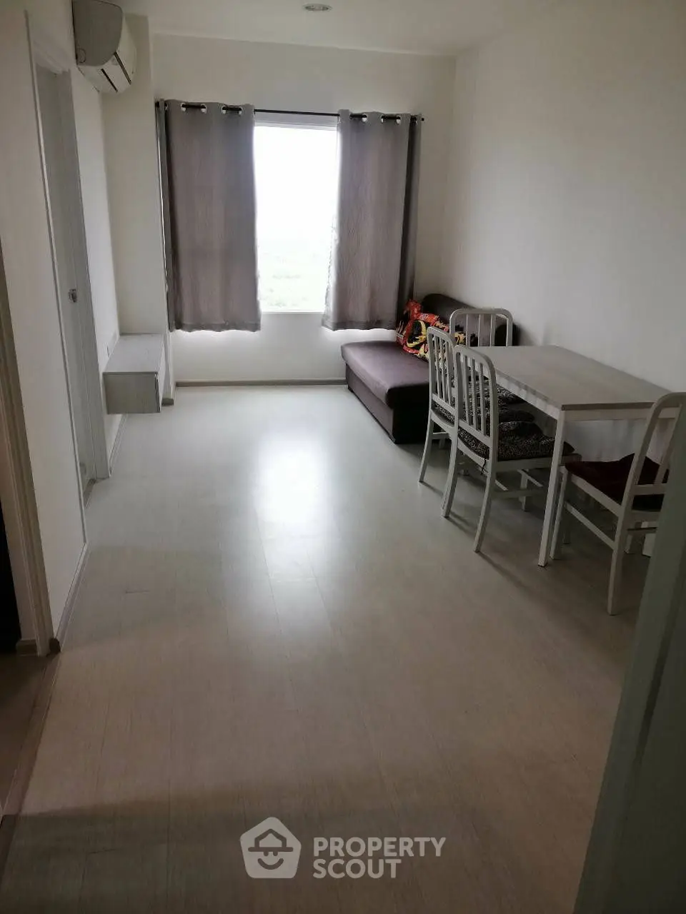 Cozy living room with dining area and natural light, perfect for small gatherings.