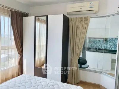 Bright bedroom with large windows and modern wardrobe