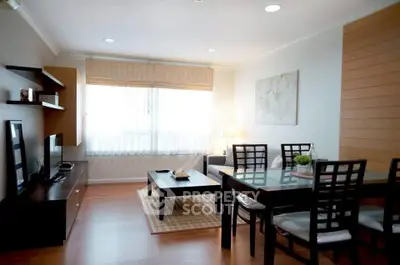 Spacious living room with modern dining area and natural light