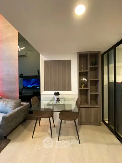 Modern living room with stylish dining area and glass table, perfect for urban living.