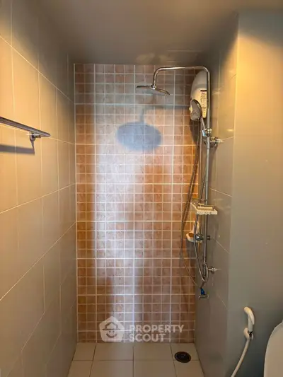 Modern bathroom shower with sleek tiles and rainfall showerhead