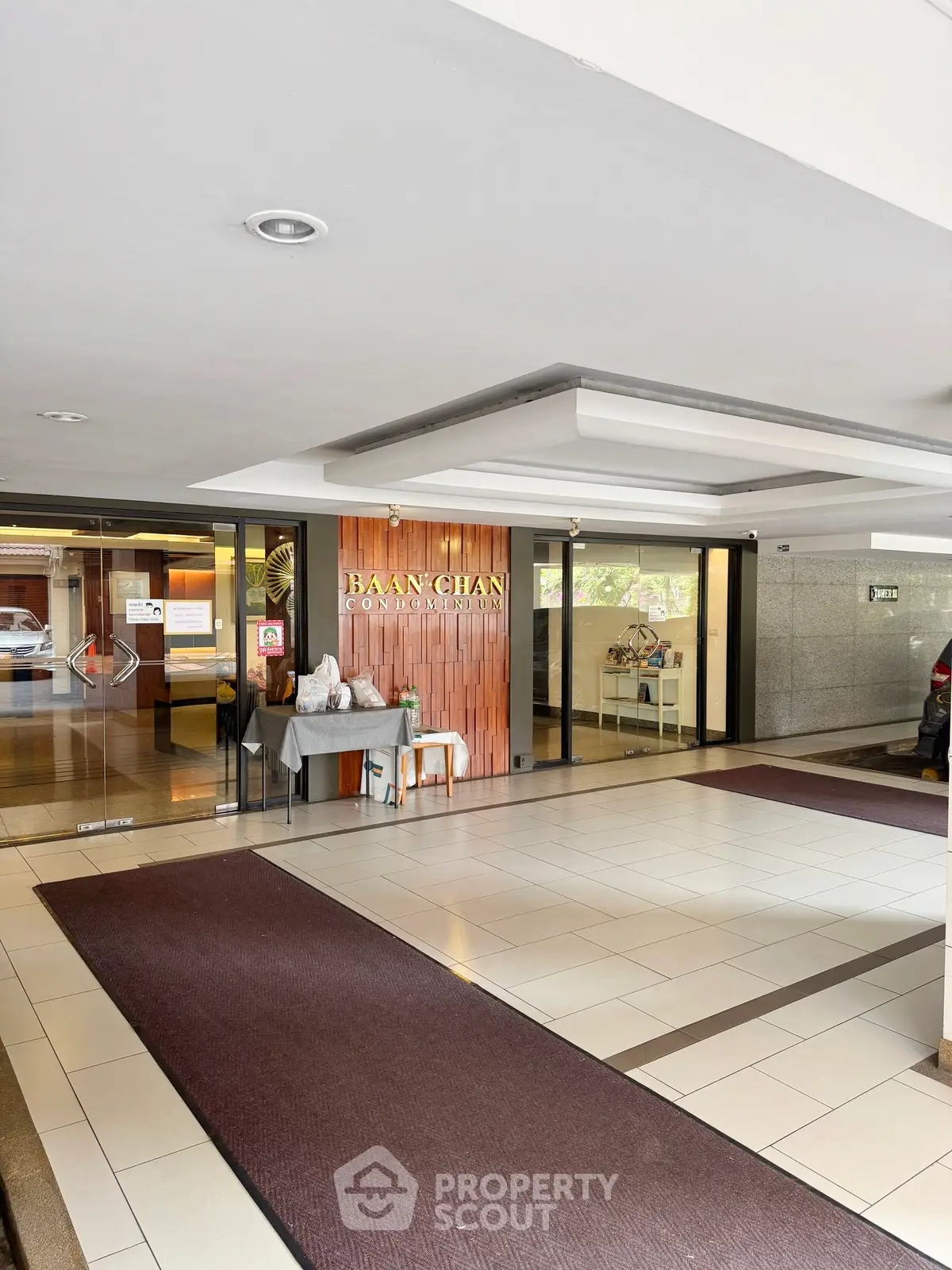 Modern condominium entrance with stylish decor and glass doors