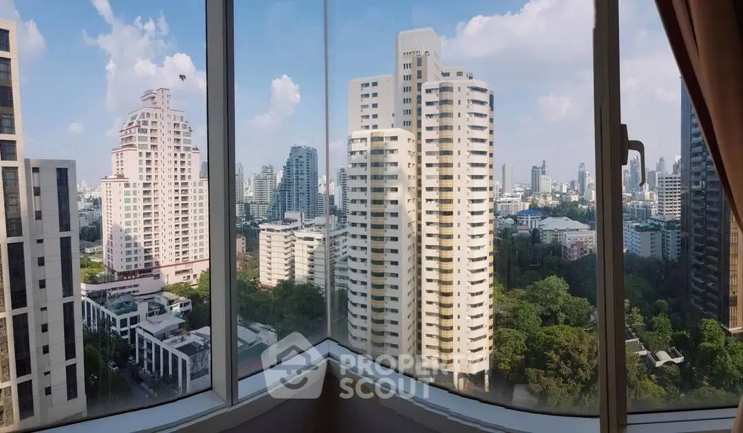 Stunning cityscape view from a high-rise apartment window, showcasing modern urban living.
